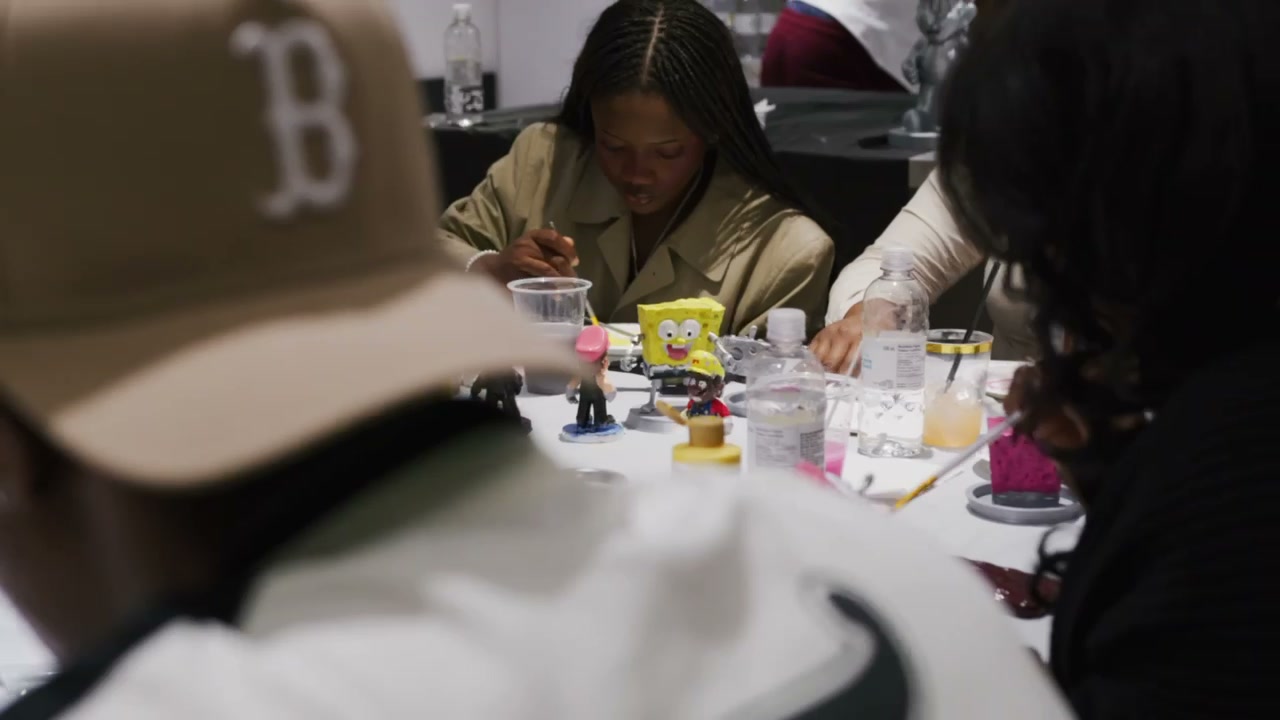 Friends painting their own figurines together at a table